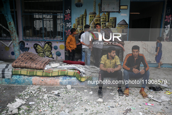 Palestinians are gathering at a UN-school that was hit during Israeli bombardment in Nuseirat, in the central Gaza Strip, on June 6, 2024, a...