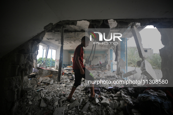 Palestinians are checking a UN-school that was hit during Israeli bombardment in Nuseirat, in the central Gaza Strip, on June 6, 2024, amid...