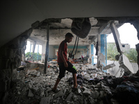 Palestinians are checking a UN-school that was hit during Israeli bombardment in Nuseirat, in the central Gaza Strip, on June 6, 2024, amid...