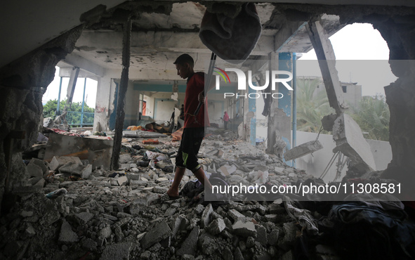 Palestinians are checking a UN-school that was hit during Israeli bombardment in Nuseirat, in the central Gaza Strip, on June 6, 2024, amid...