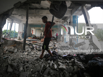 Palestinians are checking a UN-school that was hit during Israeli bombardment in Nuseirat, in the central Gaza Strip, on June 6, 2024, amid...