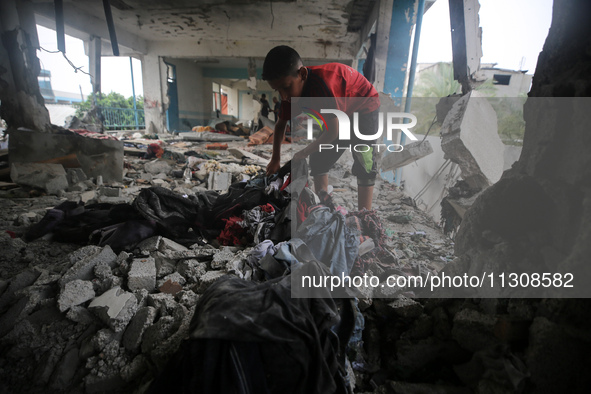 Palestinians are checking a UN-school that was hit during Israeli bombardment in Nuseirat, in the central Gaza Strip, on June 6, 2024, amid...