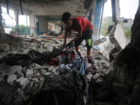 Palestinians are checking a UN-school that was hit during Israeli bombardment in Nuseirat, in the central Gaza Strip, on June 6, 2024, amid...