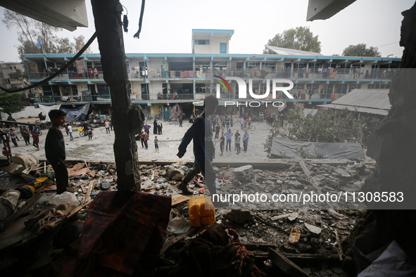 Palestinians are checking a UN-school that was hit during Israeli bombardment in Nuseirat, in the central Gaza Strip, on June 6, 2024, amid...