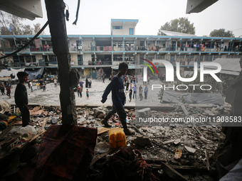 Palestinians are checking a UN-school that was hit during Israeli bombardment in Nuseirat, in the central Gaza Strip, on June 6, 2024, amid...