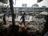 Palestinians are checking a UN-school that was hit during Israeli bombardment in Nuseirat, in the central Gaza Strip, on June 6, 2024, amid...