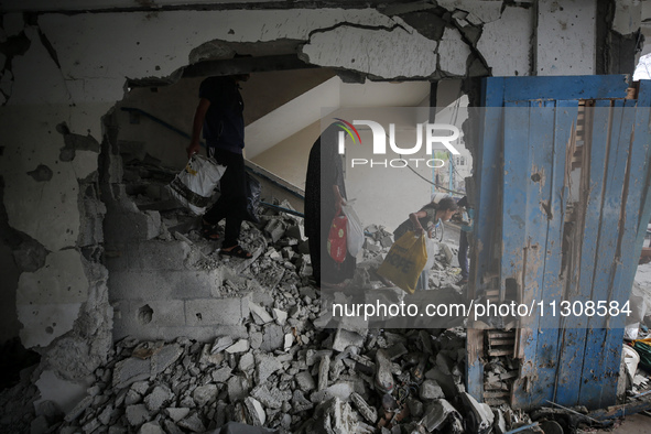 Palestinians are checking a UN-school that was hit during Israeli bombardment in Nuseirat, in the central Gaza Strip, on June 6, 2024, amid...