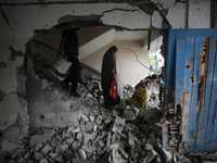 Palestinians are checking a UN-school that was hit during Israeli bombardment in Nuseirat, in the central Gaza Strip, on June 6, 2024, amid...