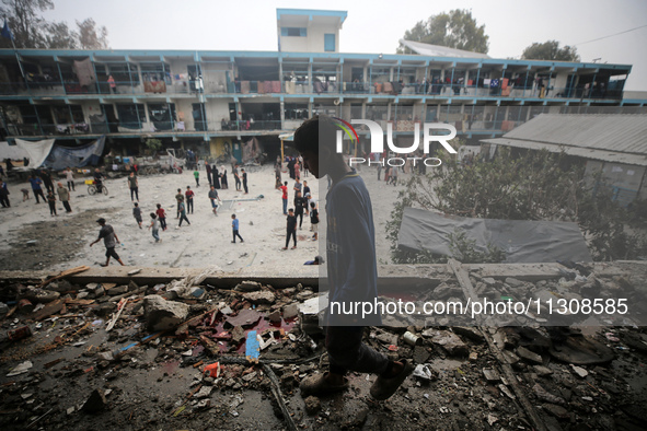 Palestinians are checking a UN-school that was hit during Israeli bombardment in Nuseirat, in the central Gaza Strip, on June 6, 2024, amid...