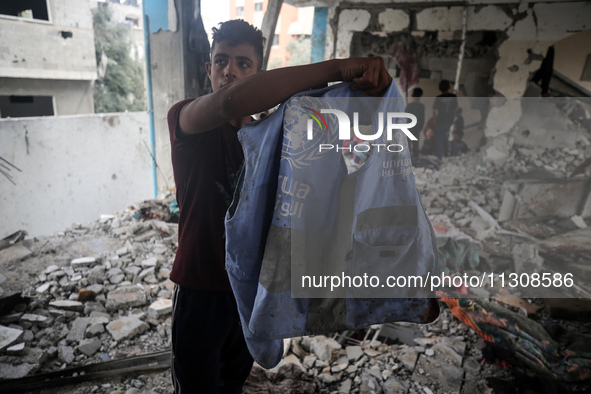 Palestinians are checking a UN-school that was hit during Israeli bombardment in Nuseirat, in the central Gaza Strip, on June 6, 2024, amid...