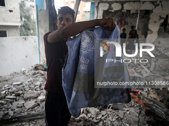 Palestinians are checking a UN-school that was hit during Israeli bombardment in Nuseirat, in the central Gaza Strip, on June 6, 2024, amid...