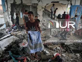 Palestinians are checking a UN-school that was hit during Israeli bombardment in Nuseirat, in the central Gaza Strip, on June 6, 2024, amid...