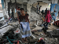 Palestinians are checking a UN-school that was hit during Israeli bombardment in Nuseirat, in the central Gaza Strip, on June 6, 2024, amid...