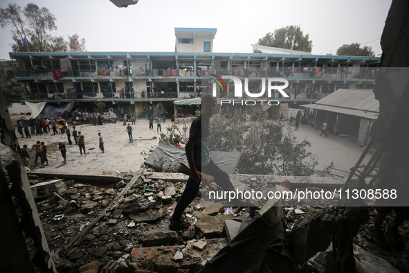 Palestinians are checking a UN-school that was hit during Israeli bombardment in Nuseirat, in the central Gaza Strip, on June 6, 2024, amid...