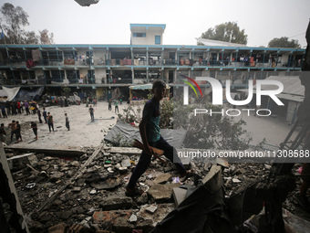 Palestinians are checking a UN-school that was hit during Israeli bombardment in Nuseirat, in the central Gaza Strip, on June 6, 2024, amid...