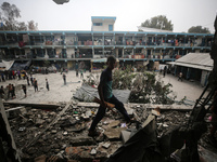 Palestinians are checking a UN-school that was hit during Israeli bombardment in Nuseirat, in the central Gaza Strip, on June 6, 2024, amid...