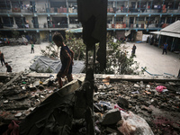 Palestinians are checking a UN-school that was hit during Israeli bombardment in Nuseirat, in the central Gaza Strip, on June 6, 2024, amid...