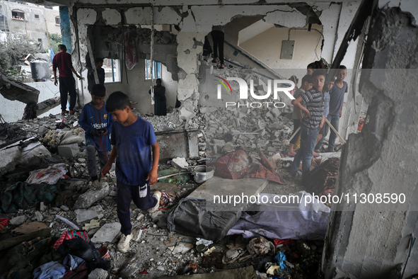 Palestinians are checking a UN-school that was hit during Israeli bombardment in Nuseirat, in the central Gaza Strip, on June 6, 2024, amid...