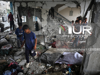 Palestinians are checking a UN-school that was hit during Israeli bombardment in Nuseirat, in the central Gaza Strip, on June 6, 2024, amid...