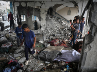 Palestinians are checking a UN-school that was hit during Israeli bombardment in Nuseirat, in the central Gaza Strip, on June 6, 2024, amid...