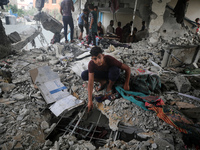 Palestinians are checking a UN-school that was hit during Israeli bombardment in Nuseirat, in the central Gaza Strip, on June 6, 2024, amid...