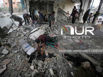 Palestinians are checking a UN-school that was hit during Israeli bombardment in Nuseirat, in the central Gaza Strip, on June 6, 2024, amid...