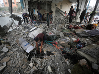 Palestinians are checking a UN-school that was hit during Israeli bombardment in Nuseirat, in the central Gaza Strip, on June 6, 2024, amid...