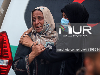 Relatives are mourning over the bodies of people killed in an Israeli airstrike at a UN school housing displaced Palestinians in Nuseirat, a...