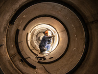 A worker is producing various types of pressure vessel equipment at a pressure vessel workshop in Nantong, Jiangsu province, China, on June...