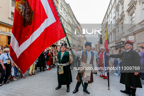 Lajkonik parade members walk in the Old Town of Krakow, Poland on June 6, 2024. Centuries long tradition of Lajkonik, a bearded man on a woo...