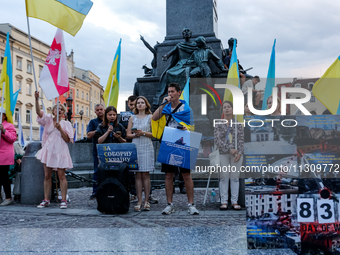 Members of Ukrainian diaspora sing during a daily demonstration of solidarity with Ukraine on the Main Square in Old Town of Krakow, Poland...