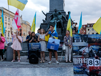 Members of Ukrainian diaspora sing during a daily demonstration of solidarity with Ukraine on the Main Square in Old Town of Krakow, Poland...