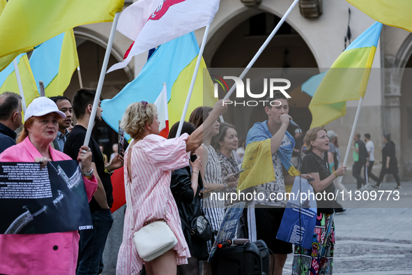 Members of Ukrainian diaspora sing during a daily demonstration of solidarity with Ukraine on the Main Square in Old Town of Krakow, Poland...