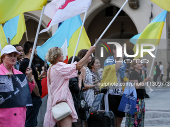 Members of Ukrainian diaspora sing during a daily demonstration of solidarity with Ukraine on the Main Square in Old Town of Krakow, Poland...