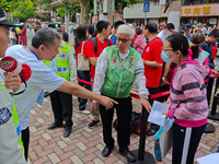 Volunteers are maintaining order as students are entering a test room to take part in the National college entrance examination in Shanghai,...