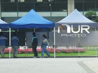 Students are learning about their test site at a college entrance examination point in Hangzhou, Zhejiang province, China, on June 7, 2024....