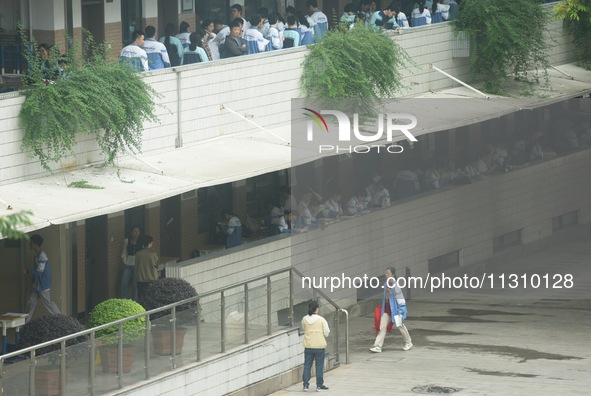 Candidates are waiting outside a test site for the National College Entrance examination in Hangzhou, China, on June 7, 2024. 