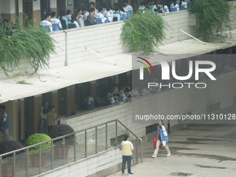 Candidates are waiting outside a test site for the National College Entrance examination in Hangzhou, China, on June 7, 2024. (