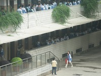 Candidates are waiting outside a test site for the National College Entrance examination in Hangzhou, China, on June 7, 2024. (