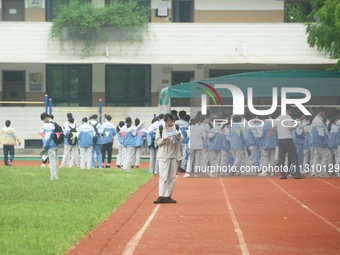 Candidates are waiting outside a test site for the National College Entrance examination in Hangzhou, China, on June 7, 2024. (