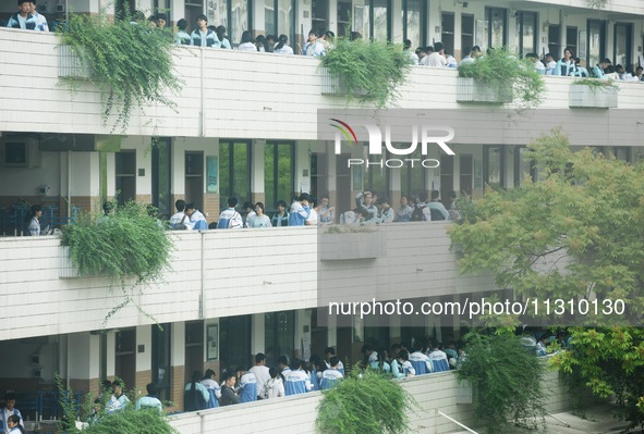 Candidates are waiting outside a test site for the National College Entrance examination in Hangzhou, China, on June 7, 2024. 