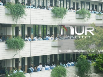 Candidates are waiting outside a test site for the National College Entrance examination in Hangzhou, China, on June 7, 2024. (