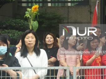 Parents are waiting outside a college entrance examination point in Hangzhou, Zhejiang province, China, on June 7, 2024. (