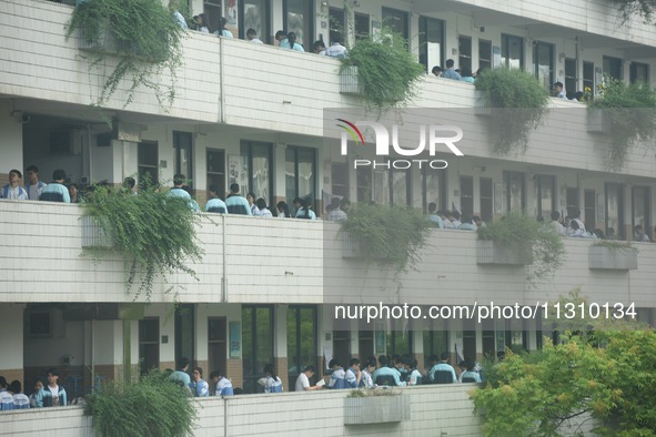 Candidates are waiting outside a test site for the National College Entrance examination in Hangzhou, China, on June 7, 2024. 