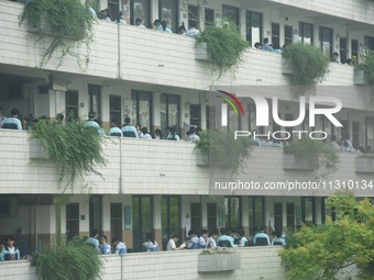 Candidates are waiting outside a test site for the National College Entrance examination in Hangzhou, China, on June 7, 2024. (