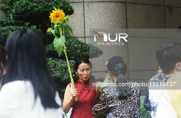 Parents are waiting outside a college entrance examination point in Hangzhou, Zhejiang province, China, on June 7, 2024. 