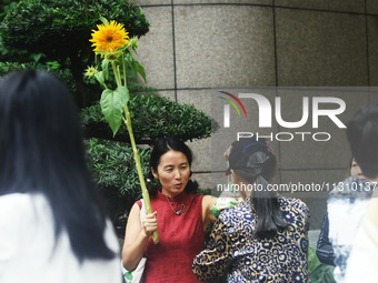 Parents are waiting outside a college entrance examination point in Hangzhou, Zhejiang province, China, on June 7, 2024. (