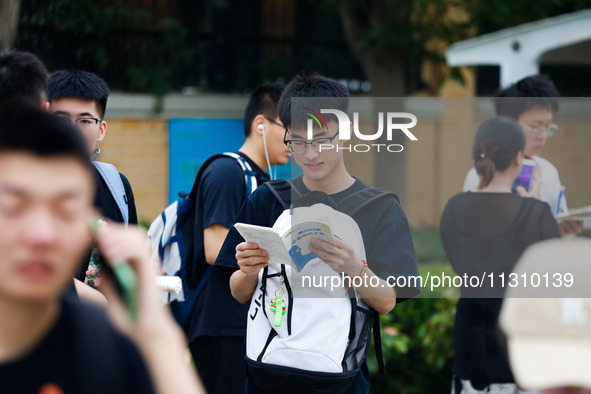 Candidates are walking into the test room for the 2024 National College entrance examination at Jinan Foreign Language School in Jinan, Chin...