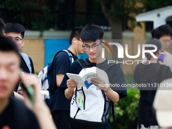 Candidates are walking into the test room for the 2024 National College entrance examination at Jinan Foreign Language School in Jinan, Chin...