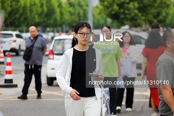 Candidates are walking into the test room for the 2024 National College entrance examination at Jinan Foreign Language School in Jinan, Chin...